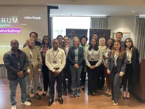 Students who attended the SpectrumX Center Meeting Fall 2023 meeting stand in a group, smiling and laughing